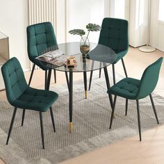 a glass table with four chairs and a potted plant on the rug in front of it