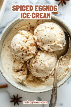 a bowl filled with ice cream and cinnamon sprinkled on the top, in front of an orange spiced eggnog