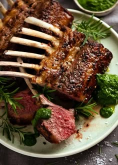 a white plate topped with meat and veggies