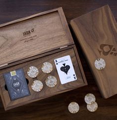 a wooden box with playing cards and poker chips