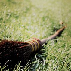 a broom laying in the grass on top of it's side