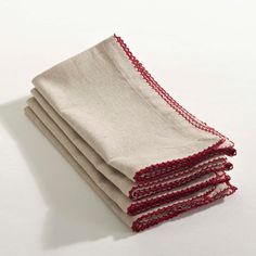 four red and white napkins stacked on top of each other