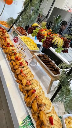 a buffet table filled with different types of food and fruit on it's sides