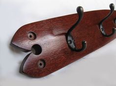 a wooden coat rack with two hooks on it