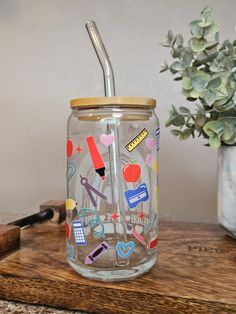 a glass jar with a straw in it sitting on a table