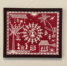 a red and white artwork hanging on the wall