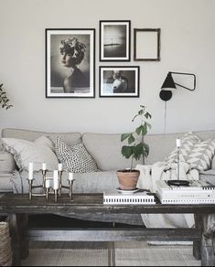 a living room filled with furniture and pictures on the wall above it's coffee table