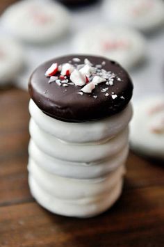 a stack of white cookies with chocolate frosting and sprinkles on top