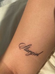 a woman's arm with a tattoo that reads, happy