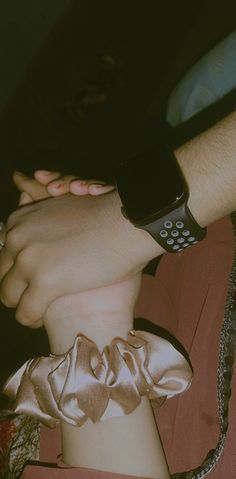 two people with their hands on each other's wrists, one holding the other