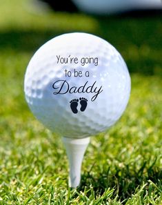 a golf ball with the words you're going to be a daddy on it