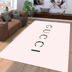 a living room with couches and a rug on the floor that says coo