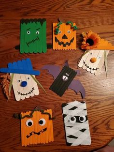 halloween crafts made out of pops sticks on a table