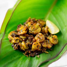 some food is sitting on top of a green leaf