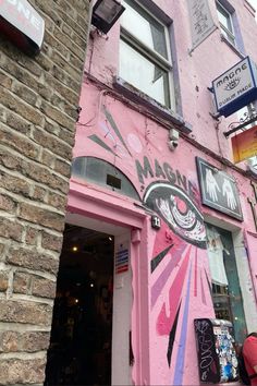 a pink building with graffiti on it's side