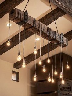 the light bulbs are hanging from the beam in the room, which is decorated with wood beams