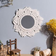 a white crocheted doily mirror hanging on the wall