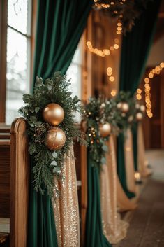 gold and green christmas decorations on the banisters in front of a large window