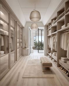 a large walk in closet with lots of clothes