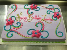 a birthday cake with pink and blue decorations