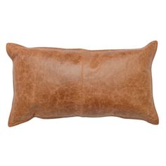 a brown leather pillow on a white background