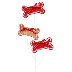 three red and white candy canes on top of each other in the shape of dogs