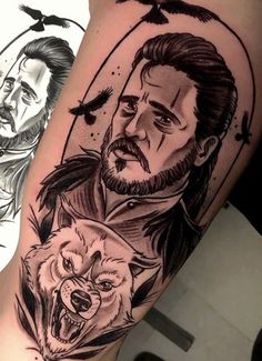 a man with a beard and two wolfs on his arm, next to him