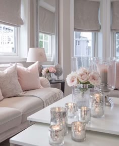 a living room filled with furniture and candles