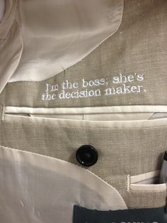 a close up of a jacket with writing on the front and back buttons in white