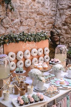 a table topped with donuts and cupcakes