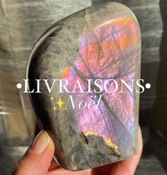 a hand holding a large rock with the words livvarisons on it's side