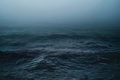 black and white photograph of ocean waves in fog