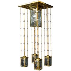 a golden chandelier with three small boxes hanging from it's sides