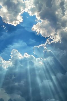 the sky is filled with clouds and sun rays