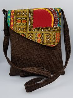 Elegant rich dashiki African print hand bag covered in a lovely pattern. This  handbag is made from 100% African Print Wax fabric.  Its interior is well lined with a black silk fabric for a smooth feel and convenient wiping.  Magnetic snap for easy opening and closing. Interior pocket for storage items.  This classic handbag is for anyone who dares to be different and can be used for casual or a special occasion, day and night depending on your mood.  It can also be a gift from you to you or to others Brown Fabric Shoulder Bag For Travel, Brown Fabric Rectangular Shoulder Bag, Brown Rectangular Fabric Shoulder Bag, Handmade Brown Fabric Bags, Brown Fabric Bags With Removable Pouch, Rectangular Fabric Shoulder Bag As Gift, Black Silk Fabric, Wax Fabric, Classic Handbags