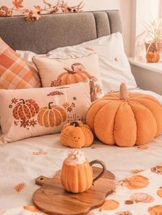 pumpkins and other decorative items on a bed