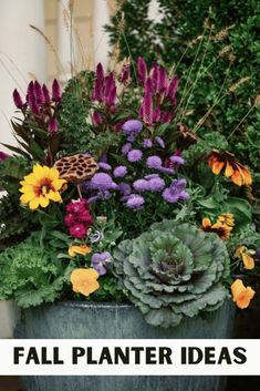 a planter filled with lots of flowers and plants