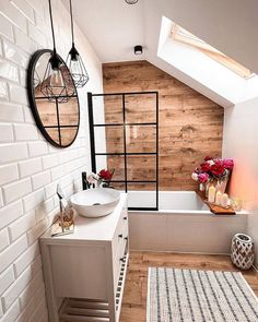 a white bathroom with wooden walls and flooring on the ceiling, along with a tub in the corner