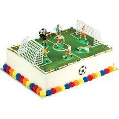 a cake with soccer players on it and balls around the perimeter, as well as a goalie's net