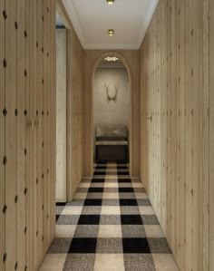 an empty hallway with checkered carpet and wooden walls