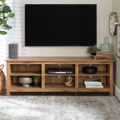 a living room with a large television mounted on the wall and a rug in front of it