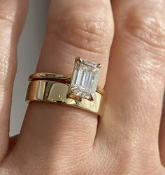 a woman's hand with a gold and white diamond ring