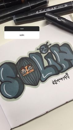 an image of graffiti written on a piece of paper with markers and pens around it