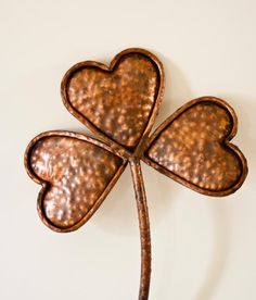 a metal four leaf clover on a white background