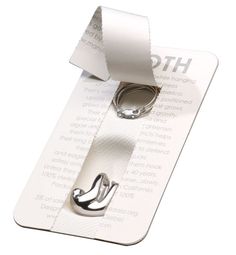 a pair of silver rings sitting on top of a white paper tag with the word htc printed on it