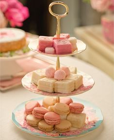 three tiered trays filled with different types of desserts