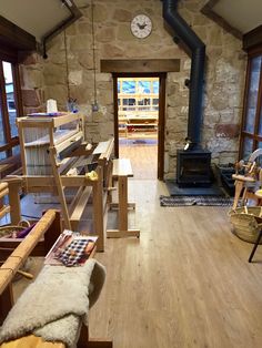 a room filled with lots of wooden furniture and a clock mounted to the side of it