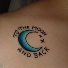 the back of a woman's shoulder with a tattoo that reads, to the moon and back