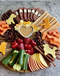 a platter filled with fruits, vegetables and crackers