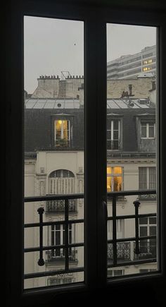 an open window with the view of buildings outside